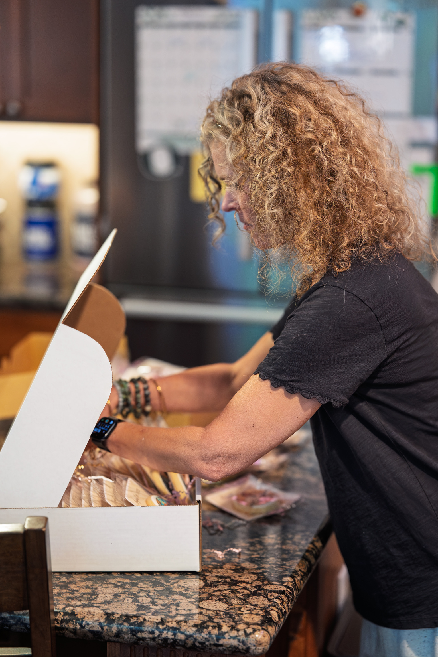 Shelly packaging cookies in her home kitchen